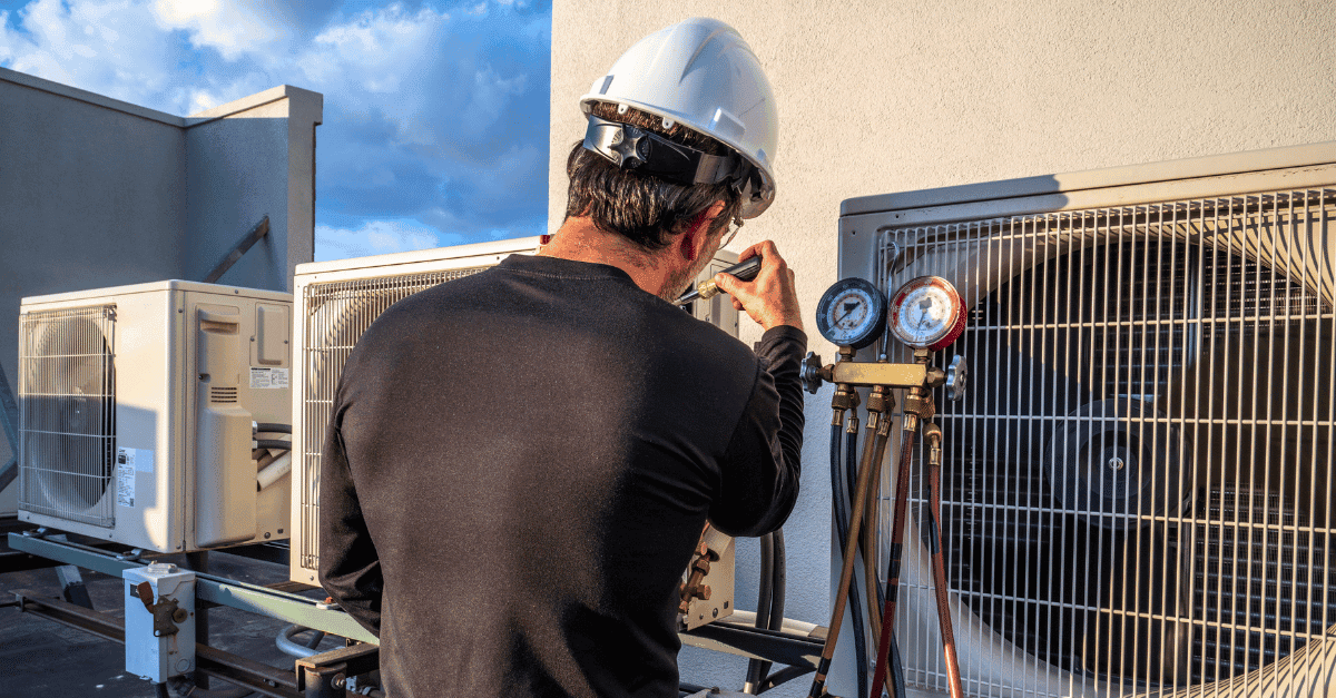 HVAC technician servicing air conditioner in a Chicago home